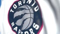 Flying flag with Toronto Raptors team logo, close-up. Editorial loopable 3D animation