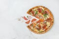 Flying food concept. Italian meat Pizza with vegetables on white marble background with ingredients Royalty Free Stock Photo