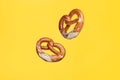 Flying Food Concept German Traditional Salted Pretzel on Yellow Background