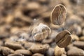 Flying fresh coffee beans as a background with copy space. Coffee beans falling down with white steam vapour. Royalty Free Stock Photo