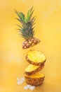 Flying  fresh ripe pineapple slices on yellow background Royalty Free Stock Photo