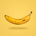 Flying banana isolated on yellow background Royalty Free Stock Photo