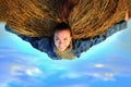 A flying girl in the clouds carries a stack of straw, an inverted photo with a girl on a haystack