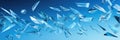 Flying glass fragments on a blue background. Wide format banner