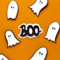 Flying Halloween ghosts whispering boo text on orange Royalty Free Stock Photo