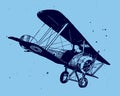 Flying antique biplane pitching down on a blue-grey background