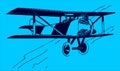 Flying historical two-seater passenger biplane aircraft on a blue background Royalty Free Stock Photo