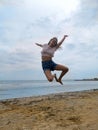 Flying jump beach girl on blue sea shore in summer vacation Royalty Free Stock Photo