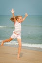 Flying jumping beach girl at blue sea shore