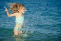 Flying jumping beach girl at blue sea shore