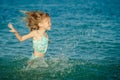 Flying jumping beach girl at blue sea shore