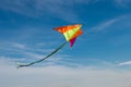 Flying a kite. Bright kite against the blue sky. Sunny day Royalty Free Stock Photo