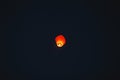 Flying lantern in the dark sky at night Royalty Free Stock Photo