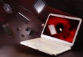 Flying in a laptop falling objects smartphone, mouse, flash, camera, tablet. Illustrative photo