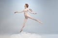 Young and graceful ballet dancer, ballerina dancing in image of angel with wings on gray studio background. Art