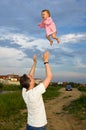 Flying little baby with father