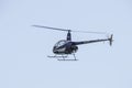 Flying little helicopter bicolor, blue and white. Robinson R22 Royalty Free Stock Photo