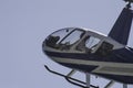 Flying little helicopter bicolor, blue and white. Robinson R22 Royalty Free Stock Photo