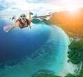 flying man happiness vacation time over beautiful blue sea traveling destination