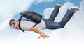 Flying man with satchel (parachute) in clouds Royalty Free Stock Photo