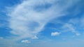 Flying moving white clouds in a blue sky. Blue sky background with many layers tiny stratus cirrus clouds. Time lapse. Royalty Free Stock Photo