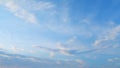 Flying moving white clouds in a blue sky. Blue sky background with many layers tiny stratus cirrus clouds. Time lapse. Royalty Free Stock Photo