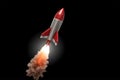 flying multi-stage space rocket with a fiery trail. Isolated on a black background. Royalty Free Stock Photo