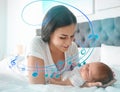 Flying music notes and woman with her newborn baby on bed. Lullaby songs Royalty Free Stock Photo