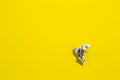 Flying origami dove on yellow background. Origami bird from music paper. Royalty Free Stock Photo