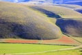 Flying over Castelluccio di Norcia, among ruins and bloom.