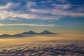 Flying over clouds and mountains Royalty Free Stock Photo