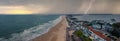 Flying over cloudy stormy beach in Bournemouth, England.