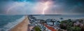 Flying over cloudy stormy beach in Bournemouth, England.