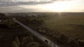 Flying over the concrete road with a moving vehicle. Stock footage. Aerial view of countryside landscape with green Royalty Free Stock Photo