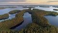 Flying over lakeland in Finland. Aerial shot of many green islands at sunset - classical Finnish landscape. Finnish Lake Royalty Free Stock Photo