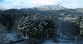 Flying over magical snow covered landscape at sunrise in New England