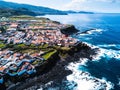 Flying over the ocean surf on the reefs coast of San Miguel island, Azores