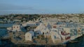 Flying over Paraportiani greek orthodox church in Mykonos island at golden hour