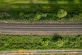 aerial drone shot of a railroad in between rural fields and vegetation Royalty Free Stock Photo