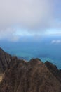 Flying over the rugged cliffs of the Napali Coast and the Pacific Ocean with boats sailing in the water in Kauai, Hawaii Royalty Free Stock Photo