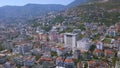 Flying over sunny town Alanya in Turkey located by the Mediterranean sea. Art. Aerial view of the mountain slope covered