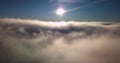 Flying over thick fog andclouds in the sunlight with blue sky, 4k video