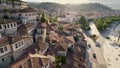 Flying over tiled roofs of houses, mosques and minarets in Berat, Albania. Magnificent Ottoman buildings in the most Royalty Free Stock Photo