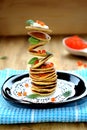 Flying pancakes, red caviar and basil leaves. Royalty Free Stock Photo