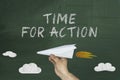 Flying paper plane and Time for action on green blackboard Royalty Free Stock Photo