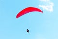 Flying paraglider on blue sky background