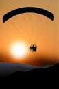 Flying paraglider silhouette at sunset