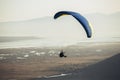 Flying paraglider.