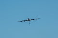 Flying passenger aircraft against a blue sky