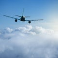 Flying of the passenger plane above the clouds and mountains Royalty Free Stock Photo